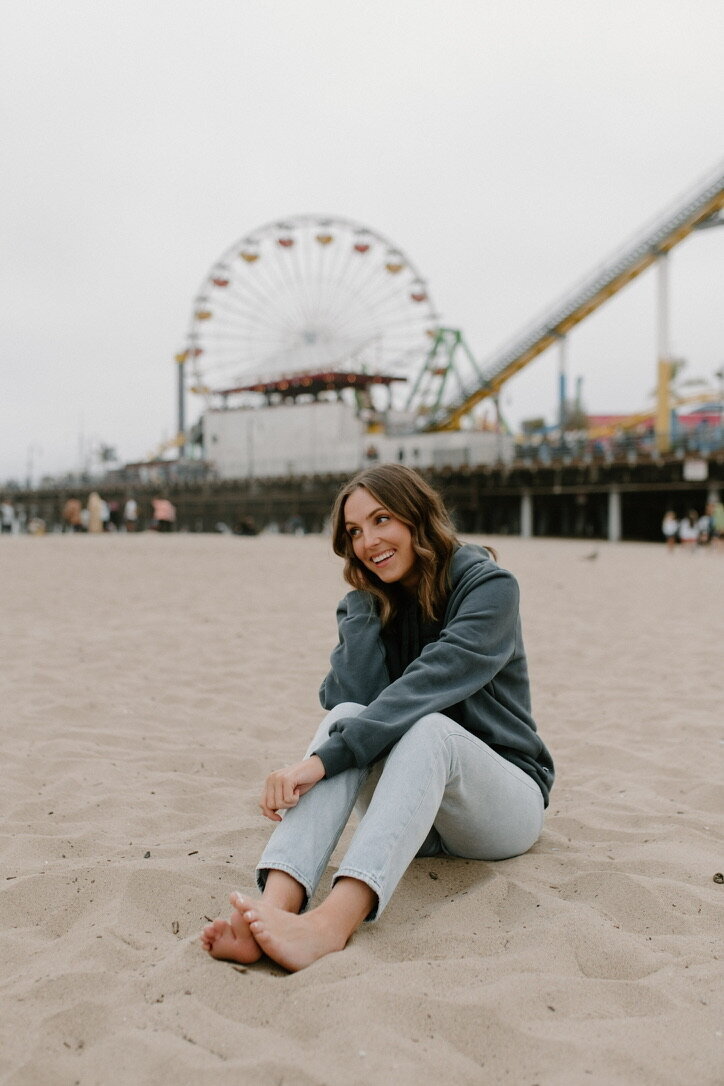 portrait on the beach with ferris wheel in background