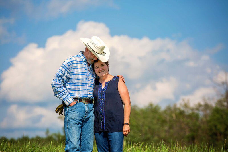 couple hugging with large blue sky