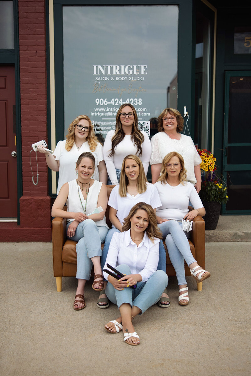 Leather styling chair and professional hair tools at Intrigue Salon, showcasing the salon’s elegant and modern interior.