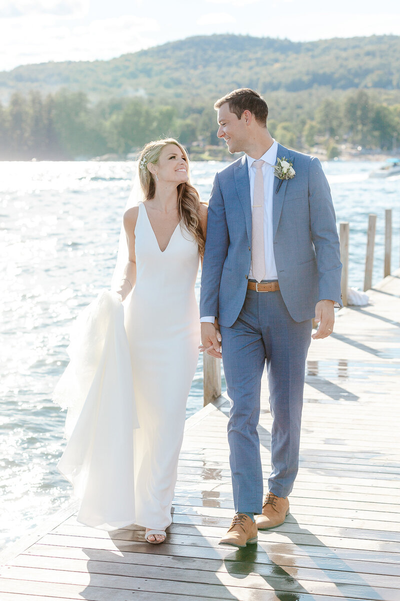 bride and groom standing on dock