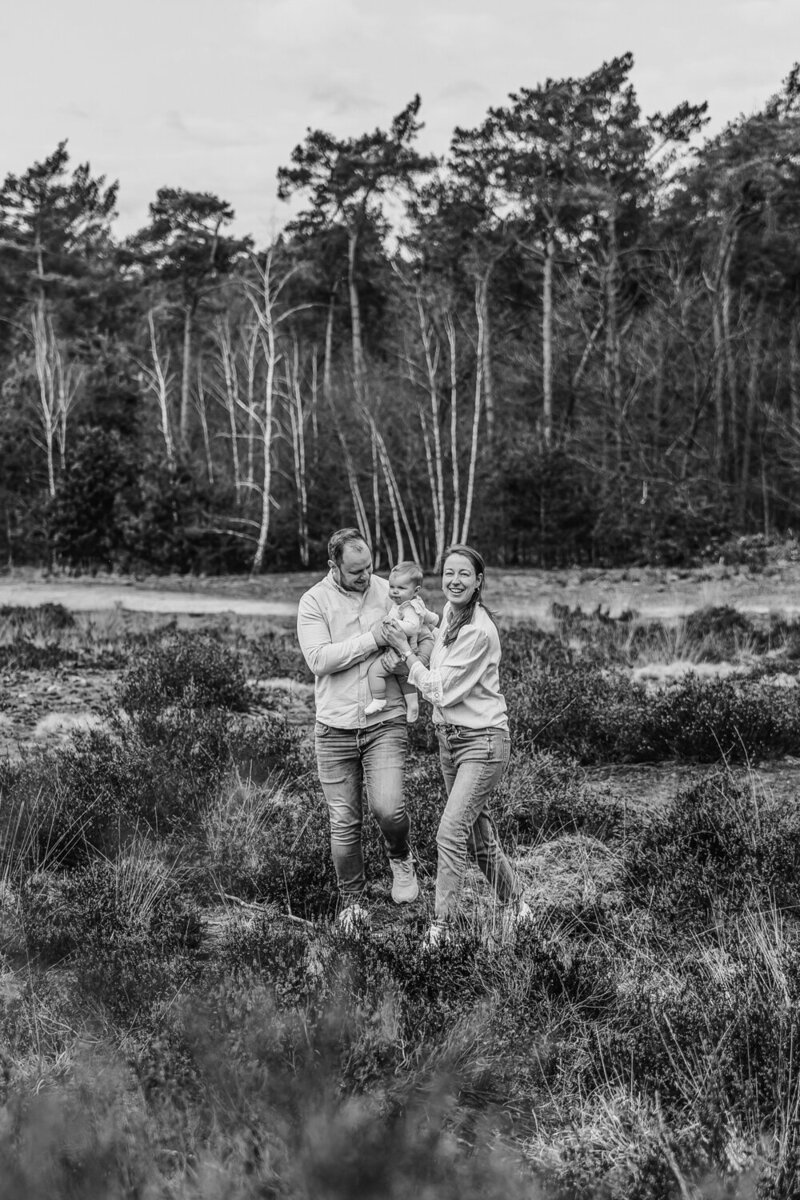 Gezin loopt samen lachend door het bos