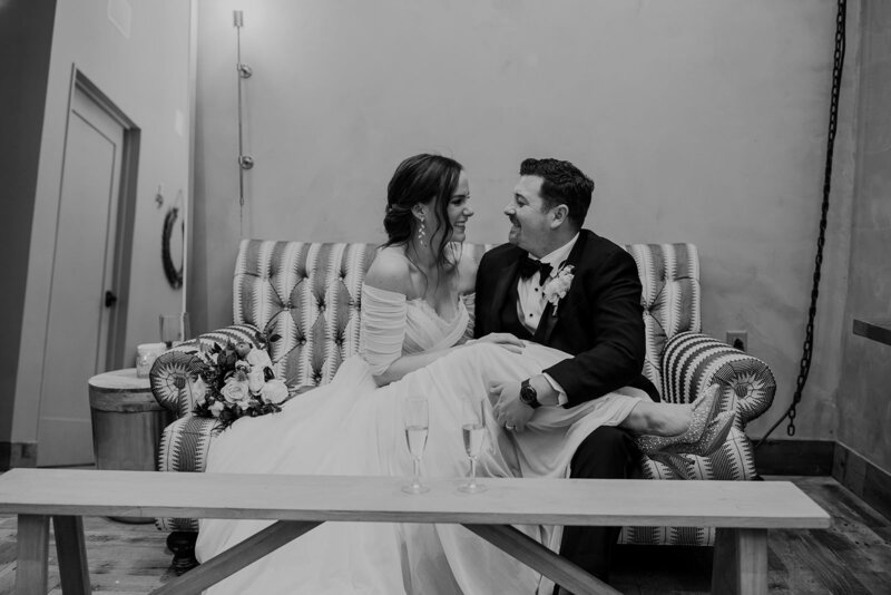 A newlywed couple sitting on a couch together