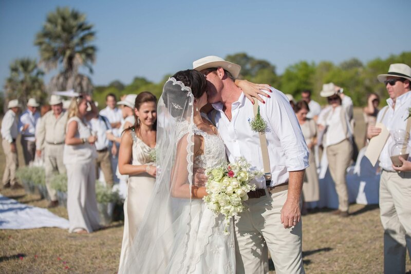 Bride and groom kissing on safari