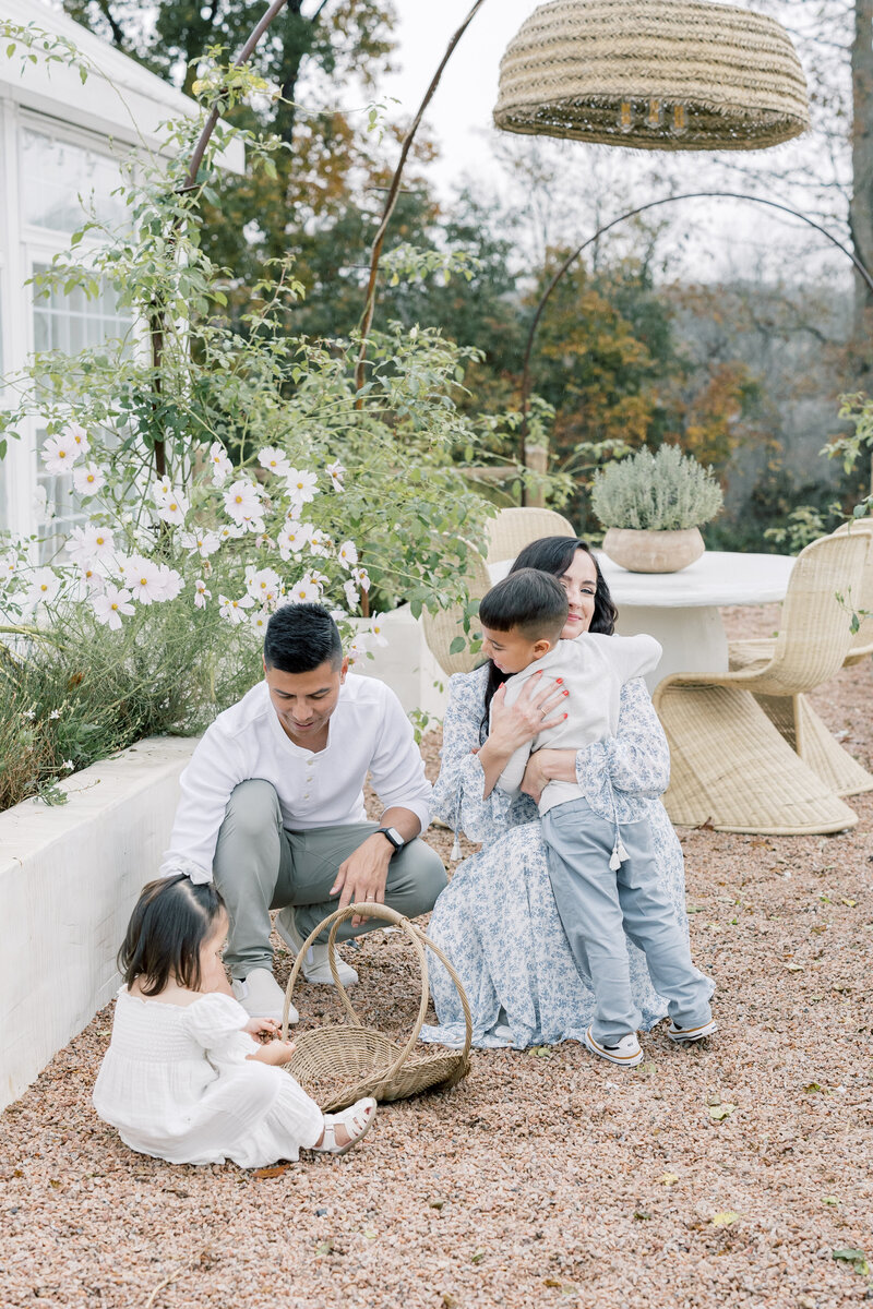Outdoor family photography session with toddler and parents walking in soft evening light at a Charlotte NC park.