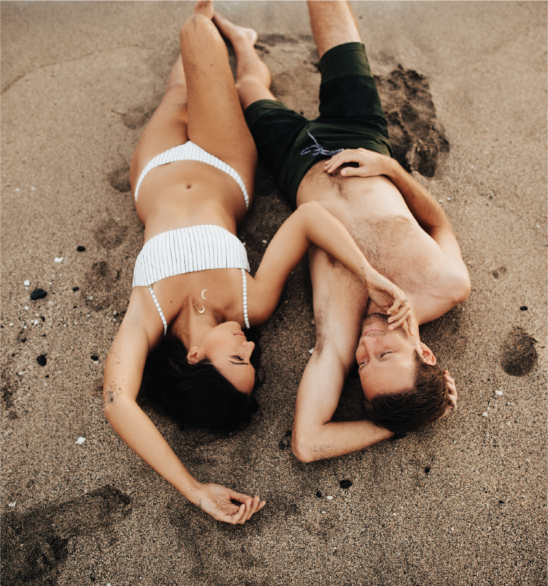 man-and-woman-at-beach-cuddling