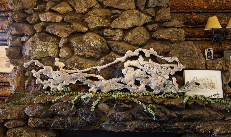 Melted metal from a forest fire decorates fireplace mantel at Colorado Mountain Ranch summer camp near Boulder
