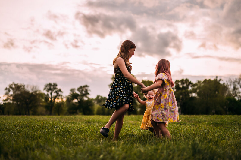 sisters playing games at sunset