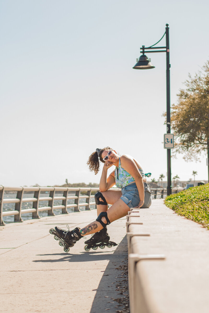 Model wears skates during creative lifestyle portrait session in Florida