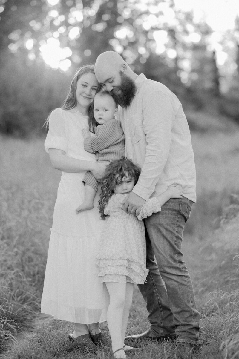 mother surrounded by family embracing her.