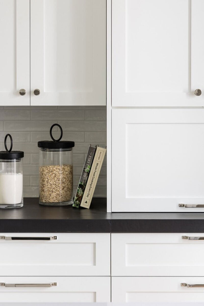 Classic transitional design with bright white cabinetry and marble surfaces
