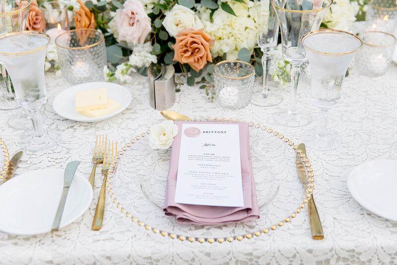 classic wedding table setting with gold flatware