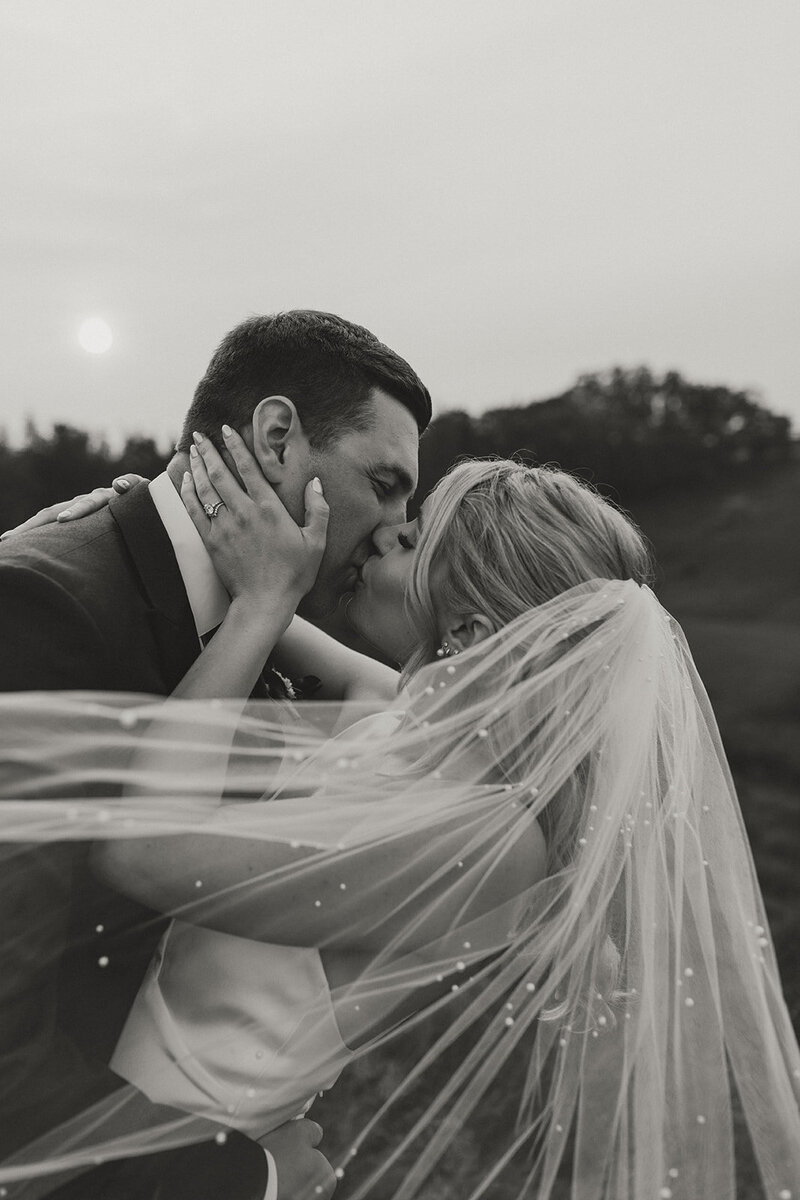 bride and groom share a kiss on wedding day in pei
