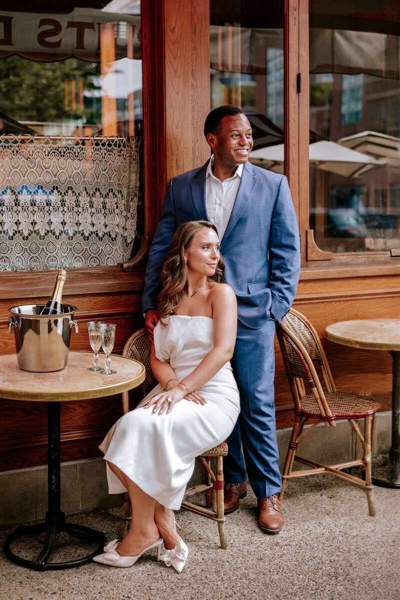 elegant-couple-sitting-at-parisian-cafe-with-champagne