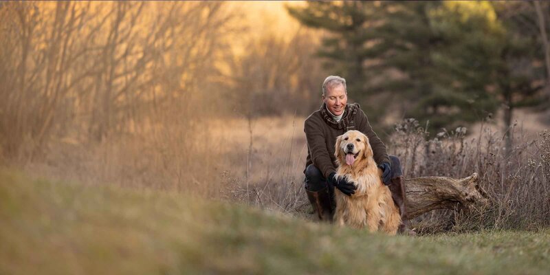 wall art of a small black dog jumping over a log