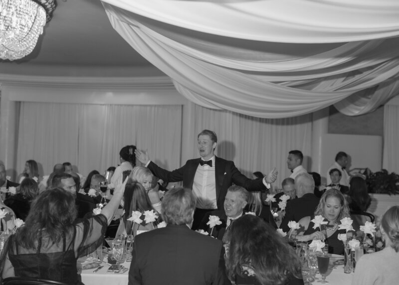 A classic, documentary-style moment of the groom sharing conversation with his friends and family at the Beverly Hills Hotel.