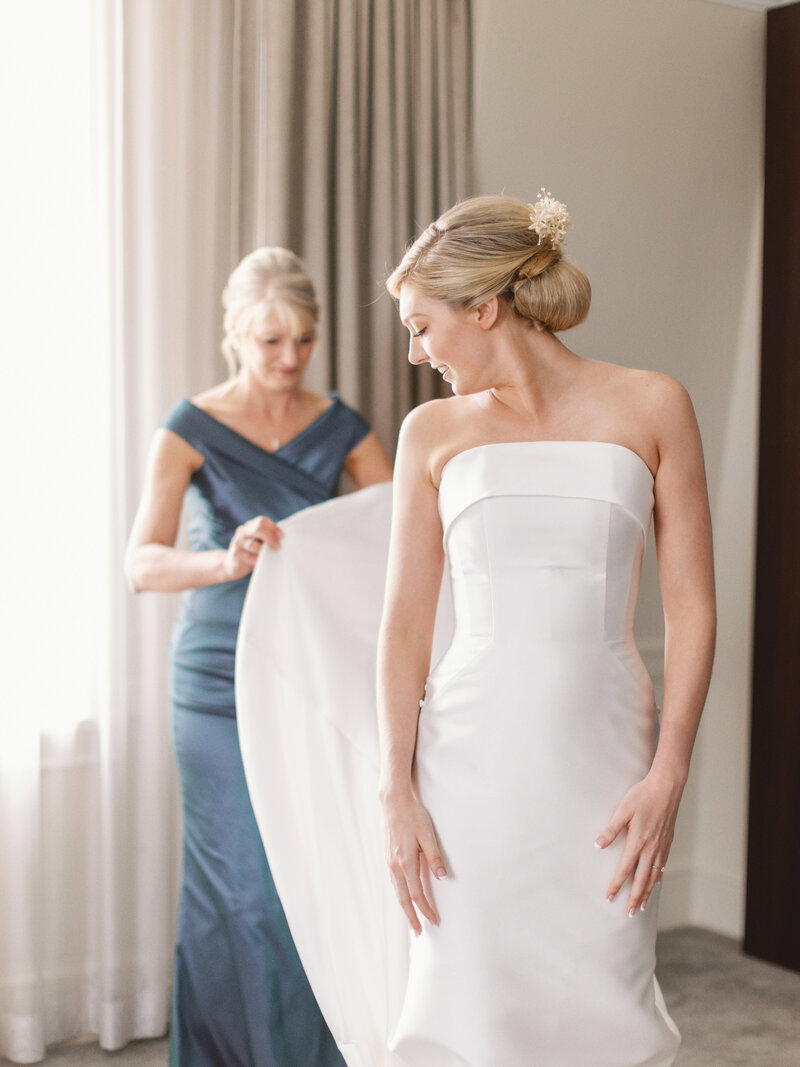 modern bride getting ready for her wedding day while wearing her heirloom bridal wax flower crown restyled into a modern hair comb
