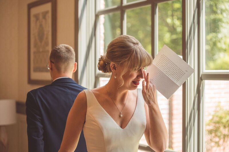 Bride crying, reading Groom's vow, during their private vow exchange