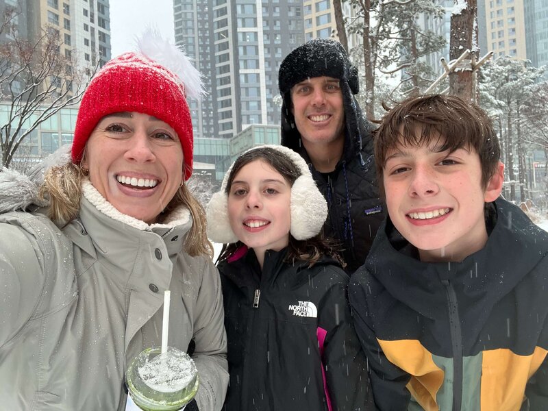 Smiling expat family in the snow — celebrating multicultural family life and parenting abroad in Seoul