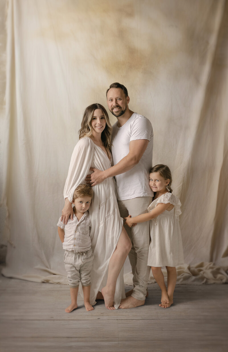 Studio portrait of parents with two children captured by Grand Rapids family photographers