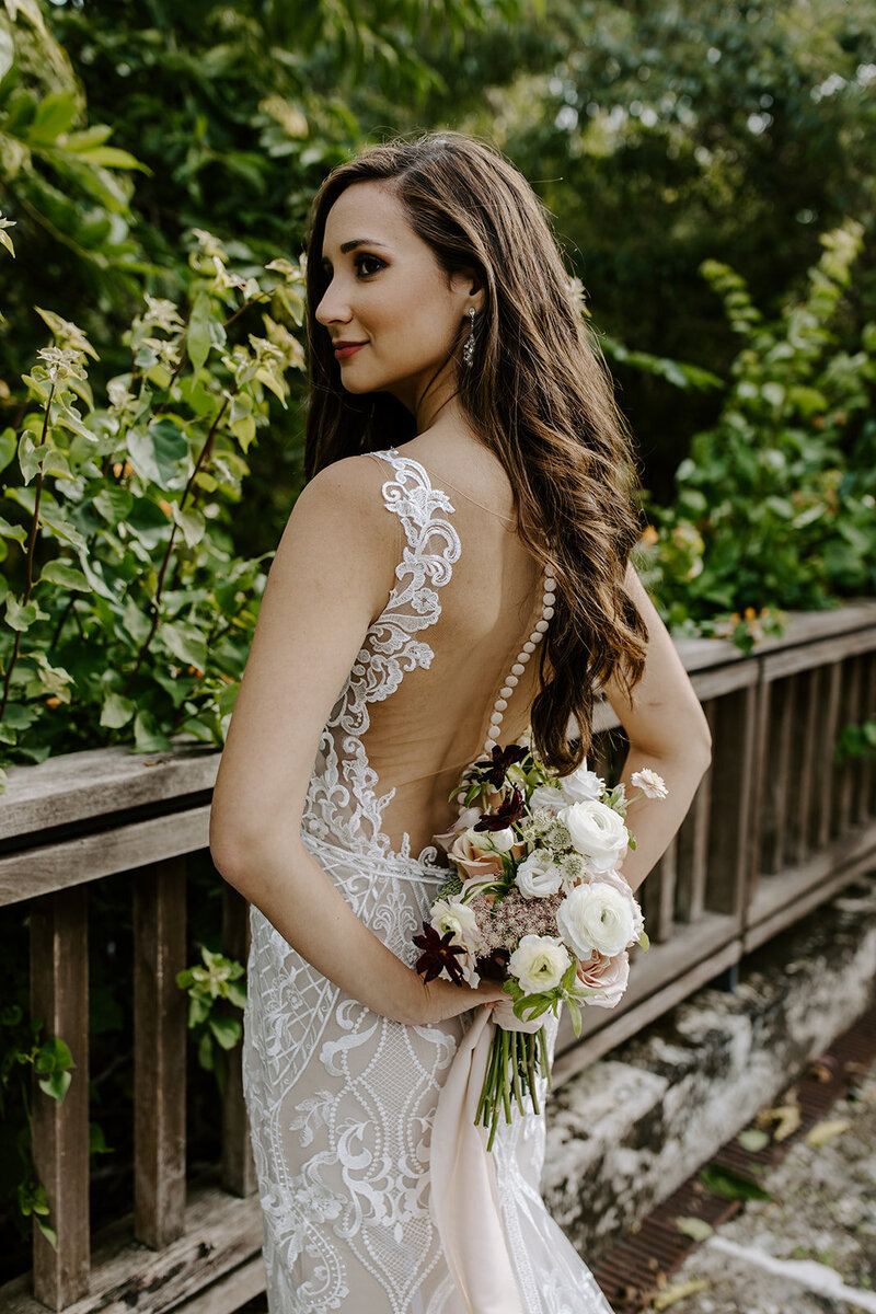 Michelle holds her incredible bouquet behind her back.