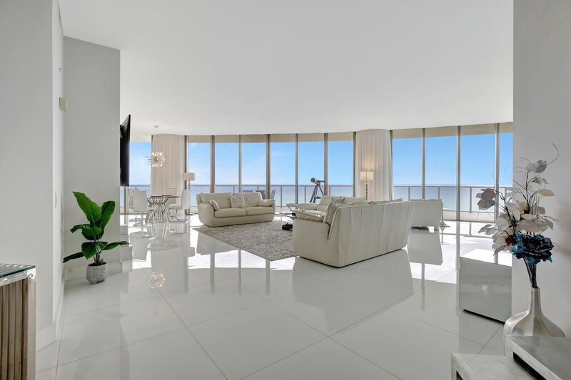 Expansive luxury living room with 10ft glass walls and direct ocean views at St. Regis PH-888