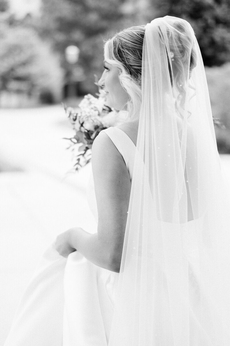 light and airy photo of a bride posing in her wedding dress