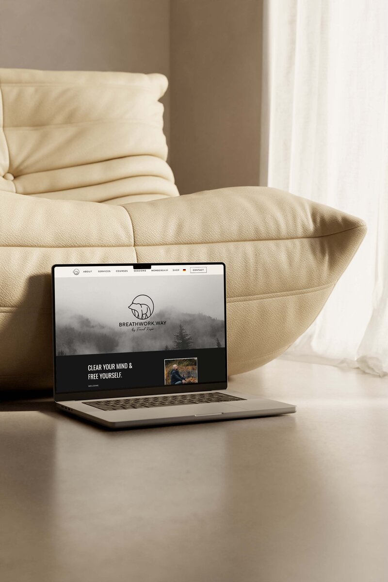 MacBook with open website in browser on the ground