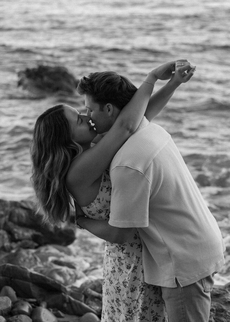 black and white engagement photo on the beach