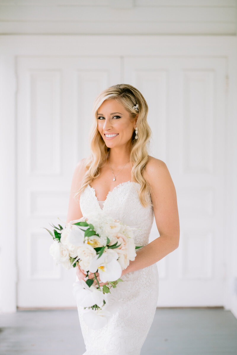 bride holding white bouquet