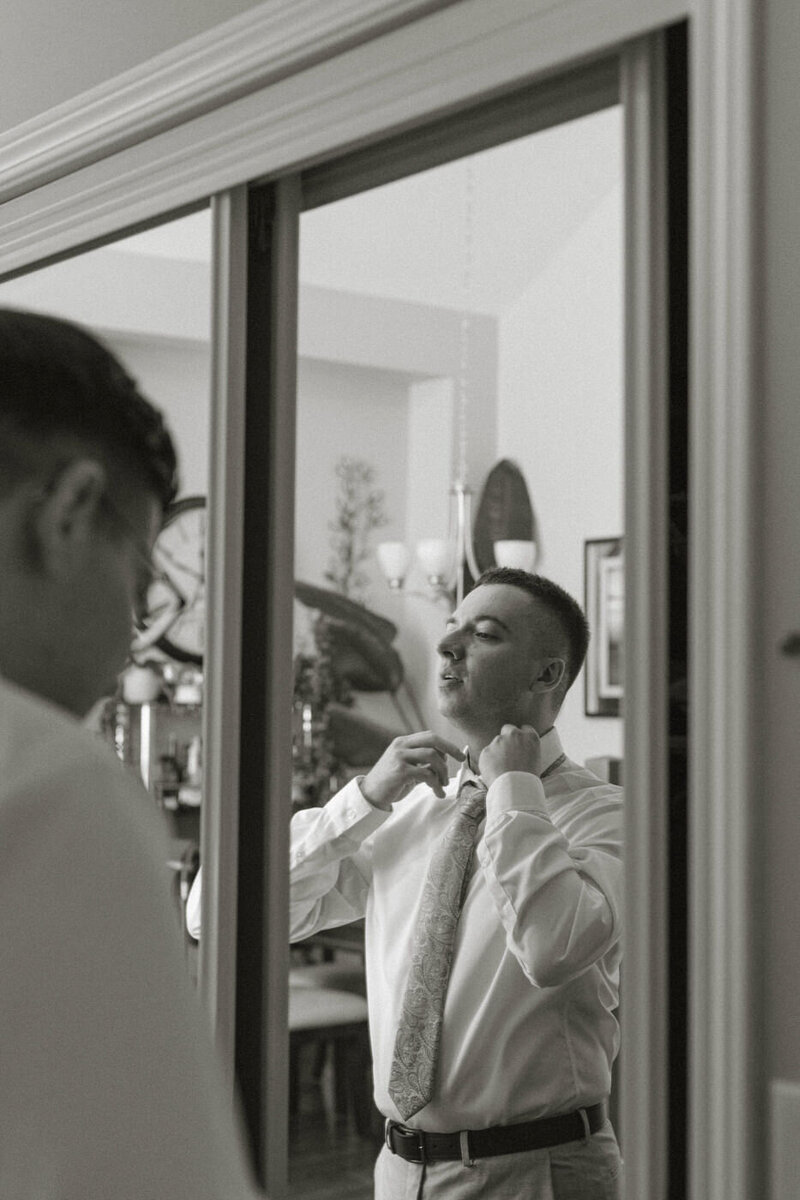 Groom getting ready with his wedding party at home 