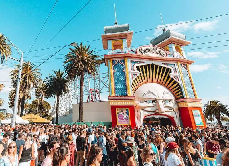 Large crowd gathered outside Luna Park's iconic entrance during St Kilda Festival in Melbourne