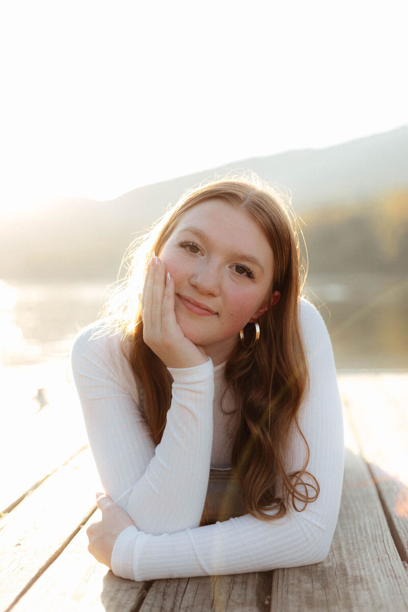 girl posing by lake