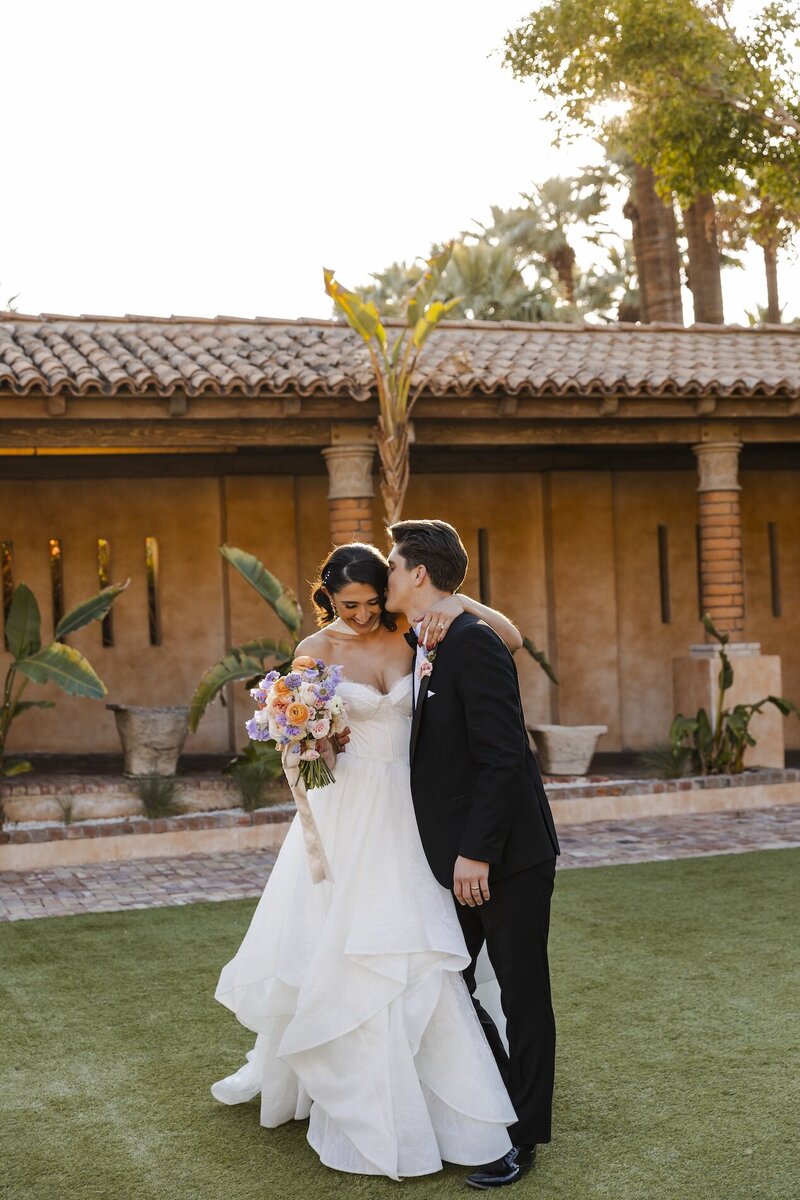 groom kisses bride after wedding in phoenix arizona