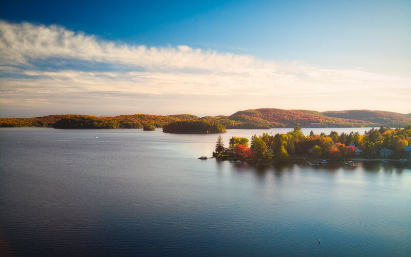 drone aerial view of Quebec foliage and lake at sunset