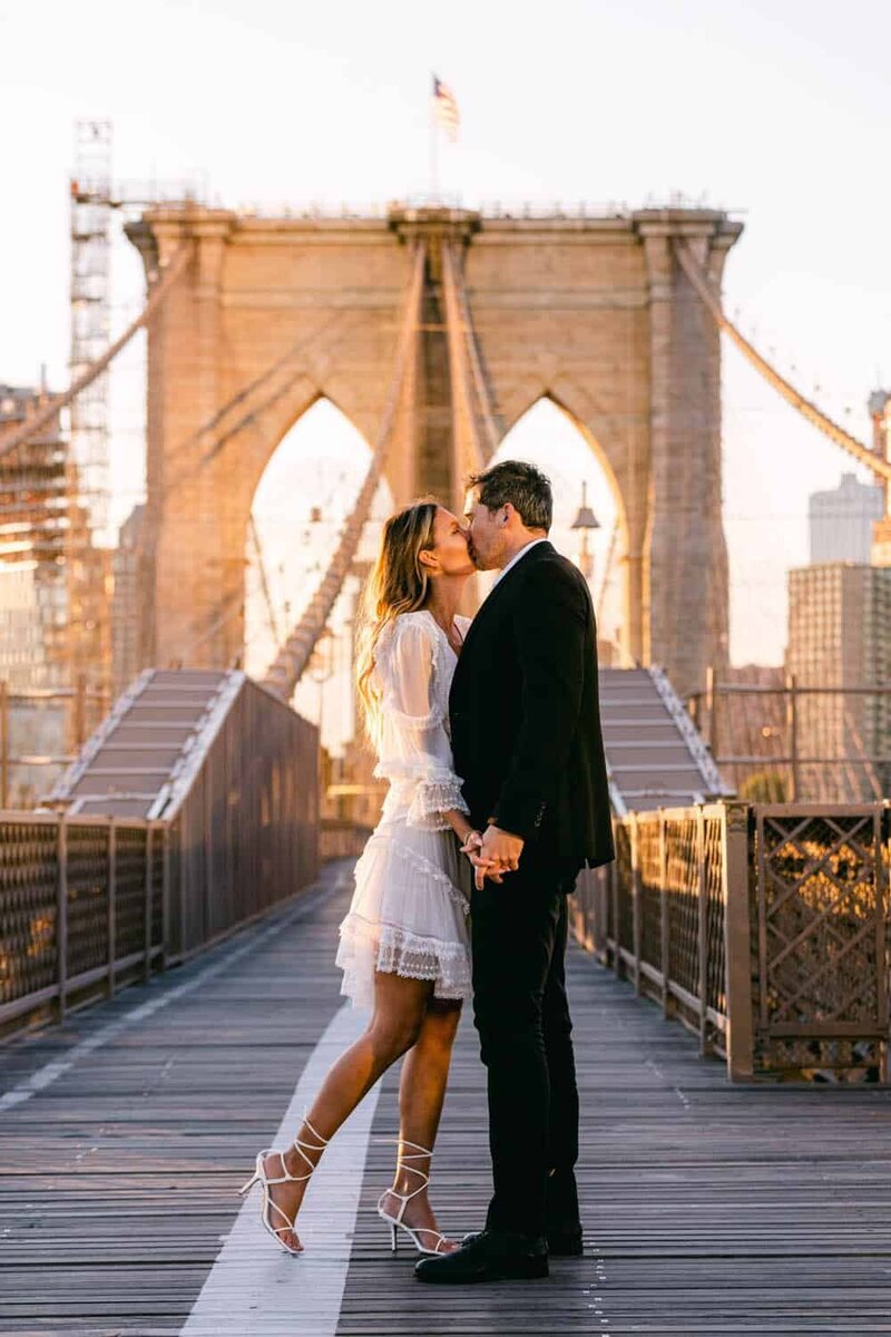 A couple get married on the Brooklyn Bridge at sunrise