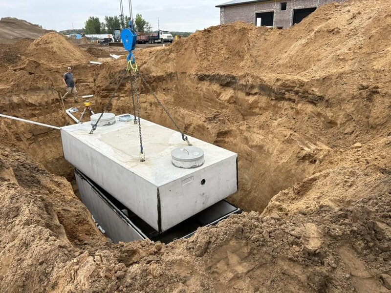 Septic tank being lowered into the ground