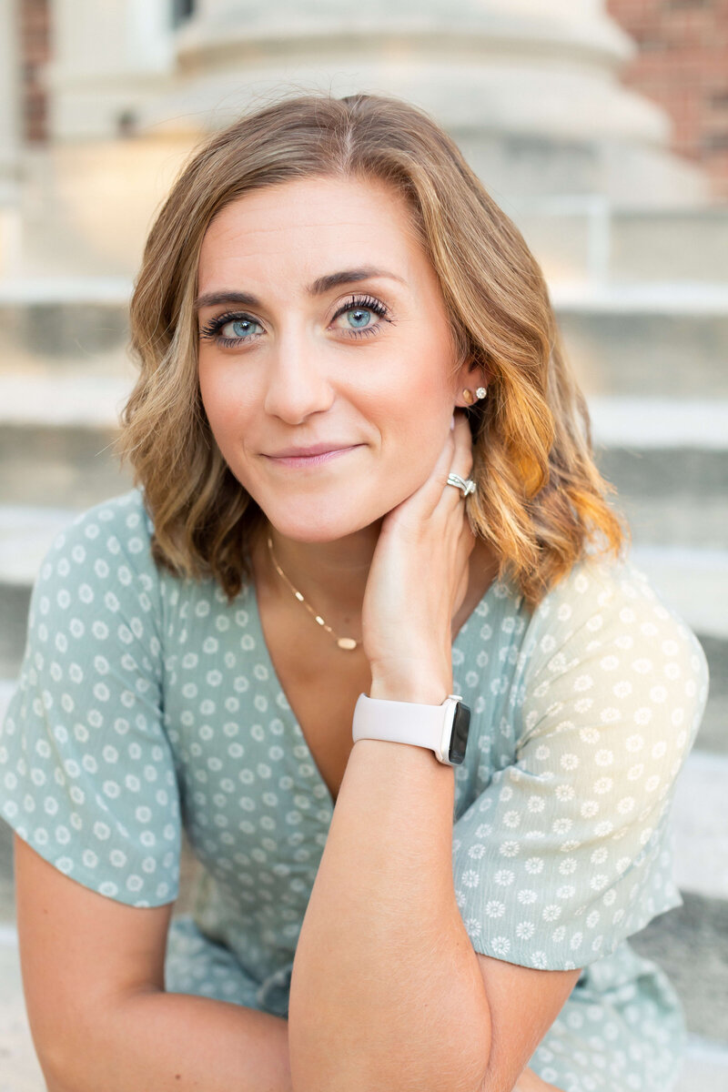 blonde woman wearing green shirt for brand shoot