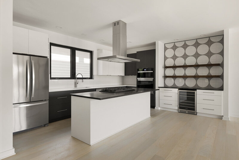 range hood over kitchen island in a modern kitchen designed by interior designer