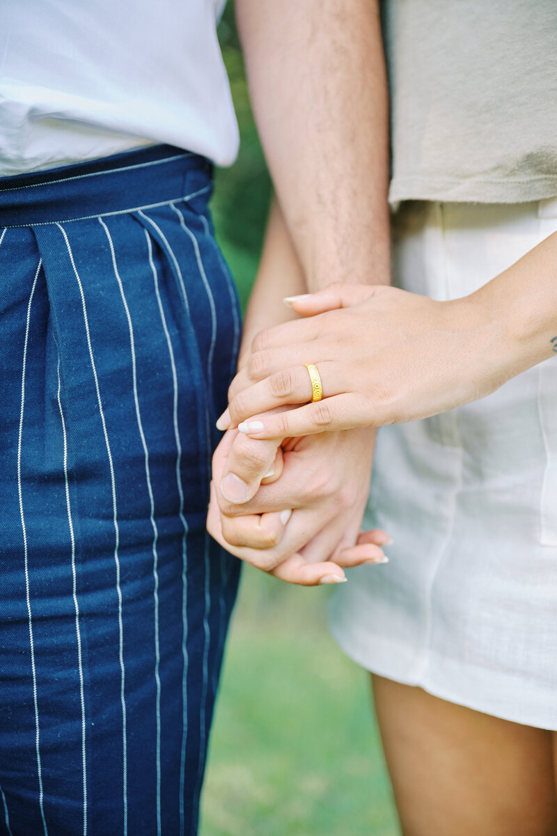 A close up photo of couple holding hands after an NYC Picnic Proposal by Corey Lamar Photography