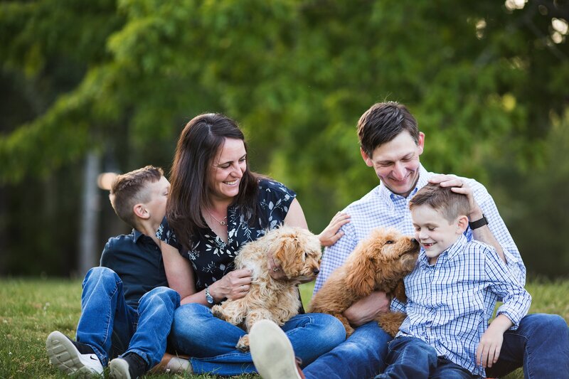 Playful Seattle Family photo of family with two boys and two goldendoodles