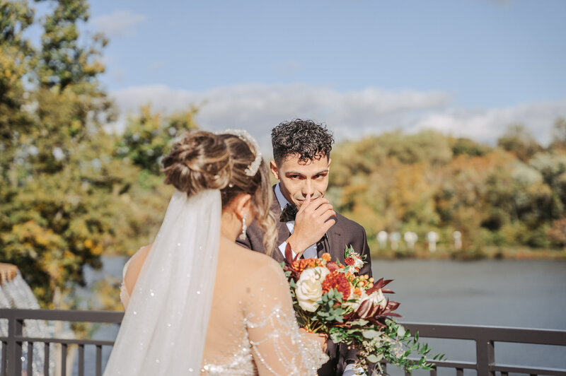 groom first look and looking at his bride