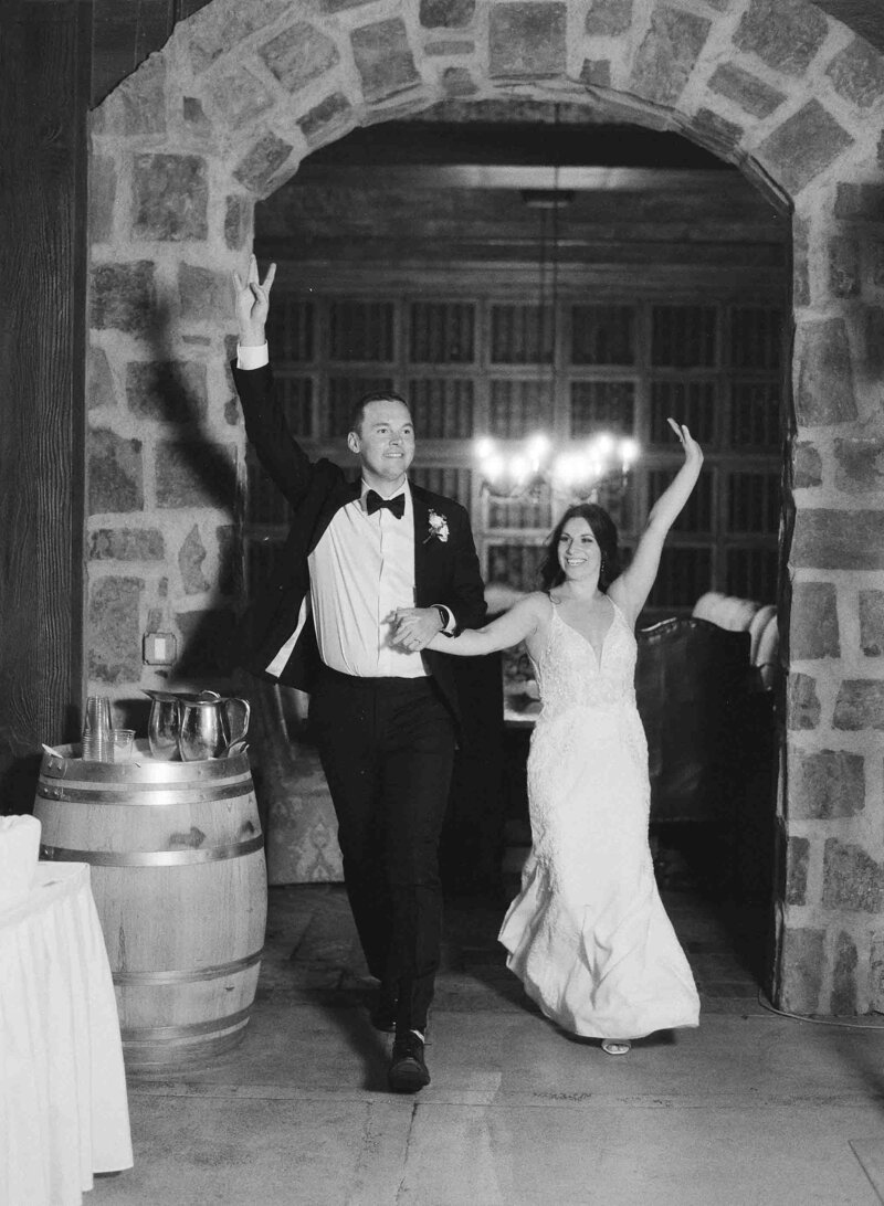grand entrance for bride and groom in a dark wine cellar wedding reception
