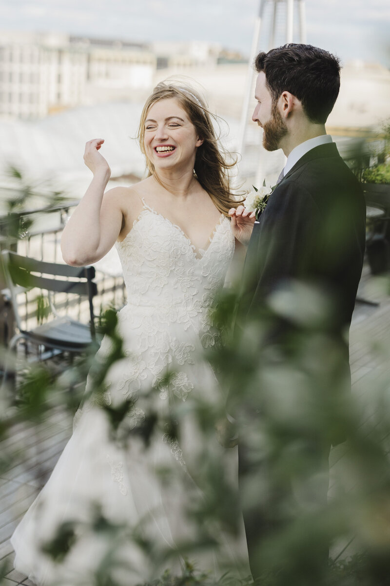 A couple smiles while having a conversation at a Riggs Hotel DC wedding.