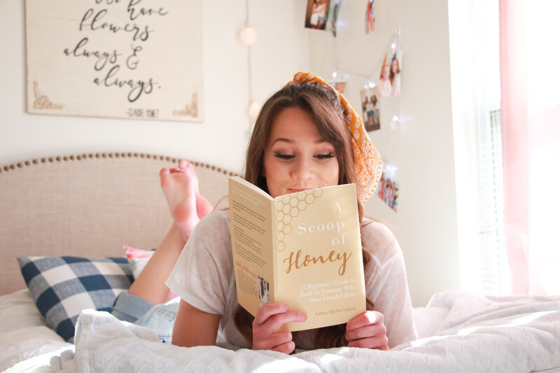 woman reading a book on bed