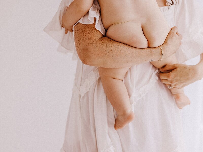 Lifestyle photo of mother holding baby
