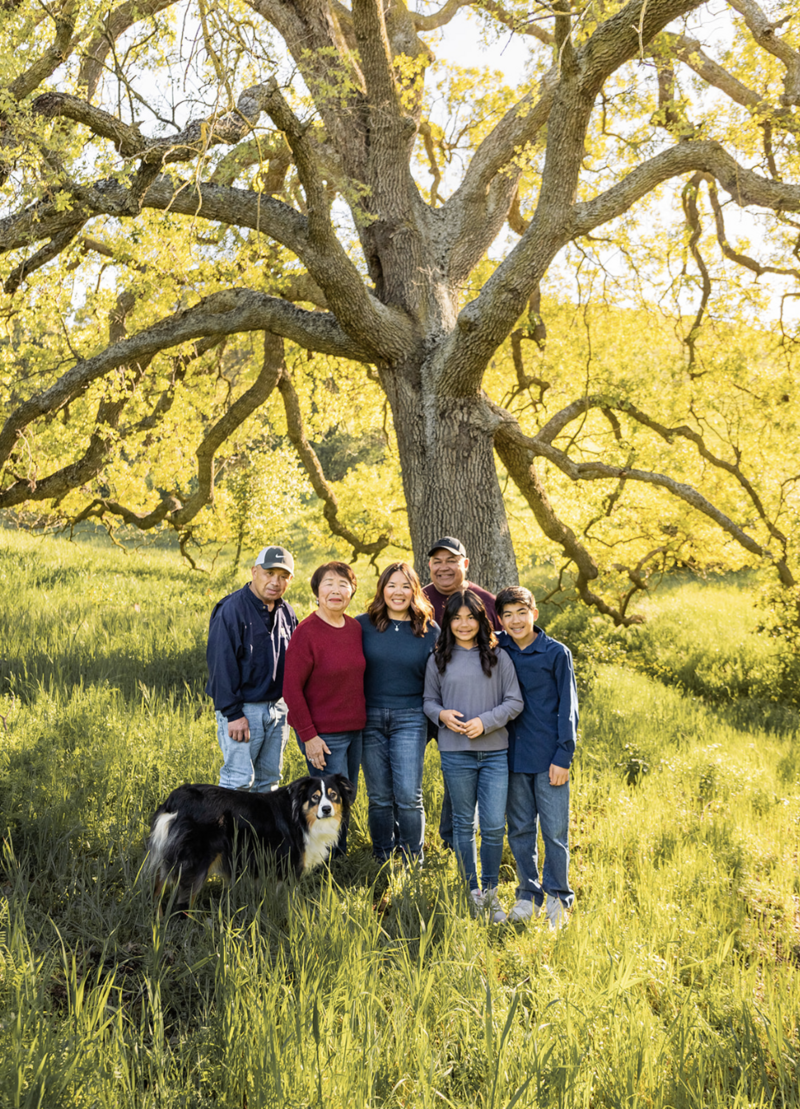 an extended family photo including the family's grandmother and their dog under a giant oak tree in san jose