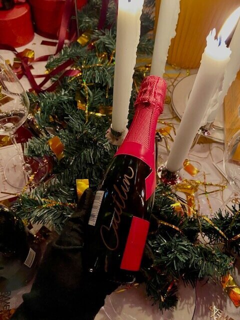 mote bottle with candles and Christmas wreath on table 