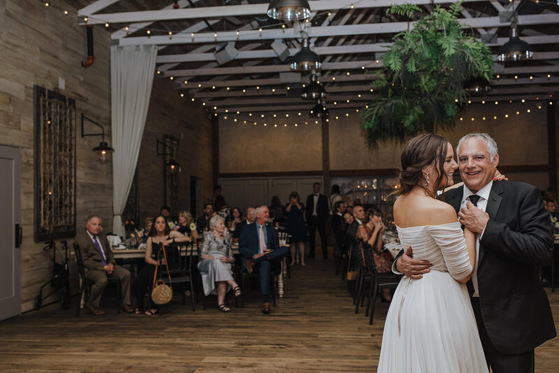 A newlywed dancing with their parent at their wedding