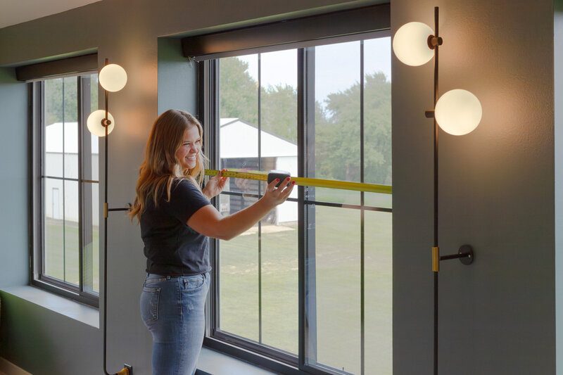 installing window treatments for client