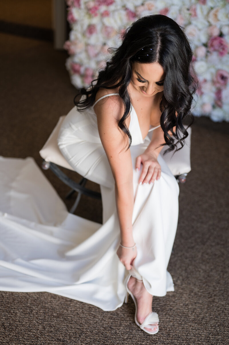 Bride getting ready at Emerald at Queensridge, wearing ‘The Archie’ gown from Love and Lace Bridal Salon.
